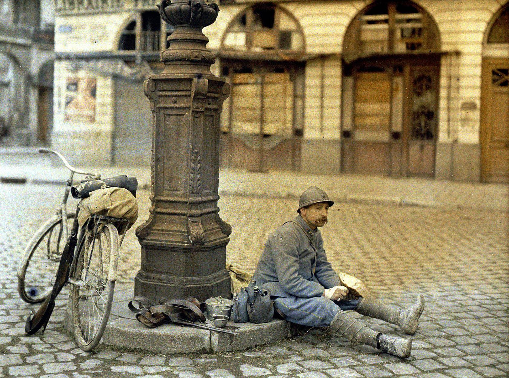 Paul Castelnau, Déjeuner de poilu : soldat en bleu horizon avec au fond une librairie endommagée place Royale, 1917/04/01
