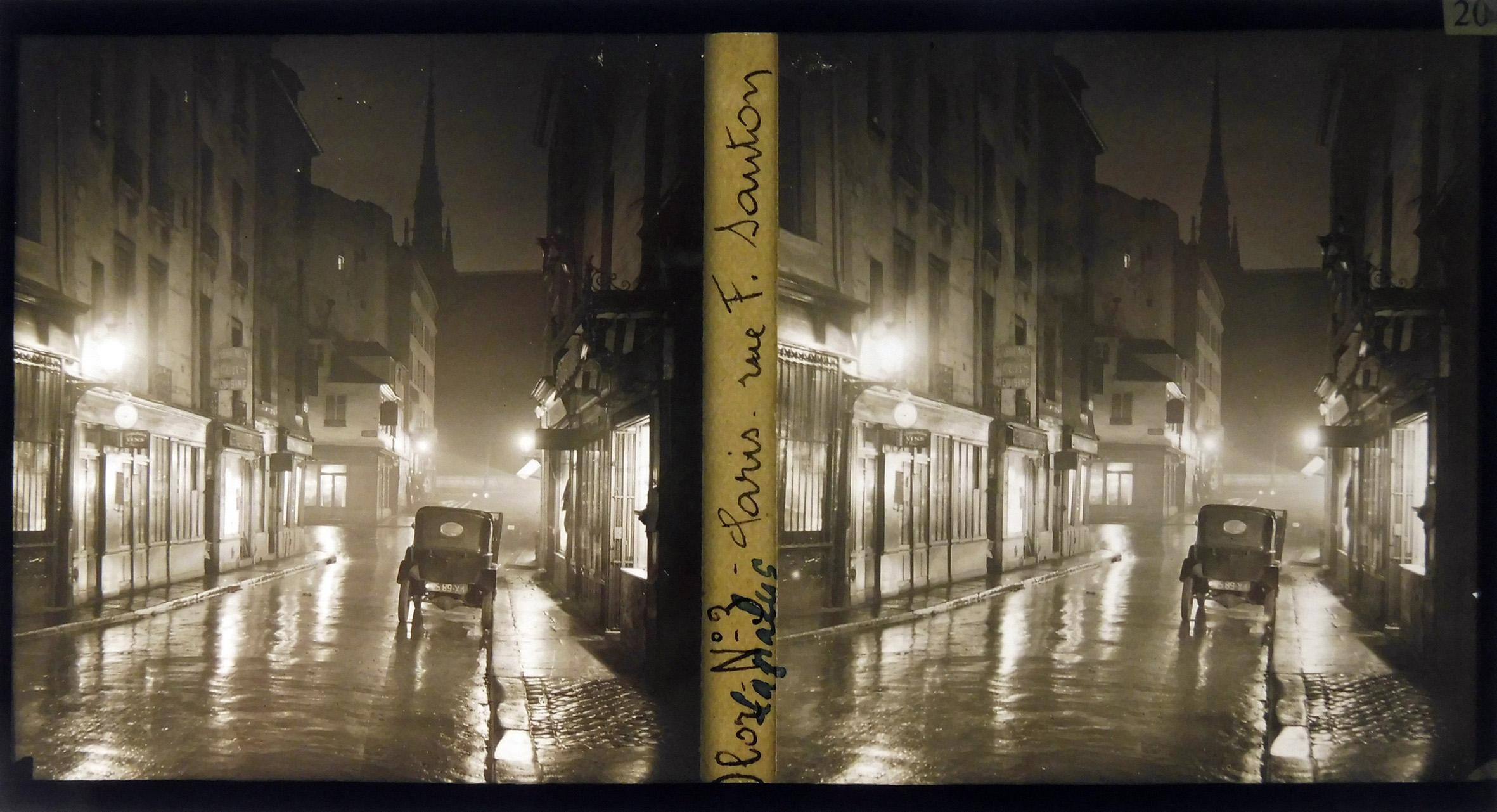 Une voiture dans une rue de nuit, après la pluie